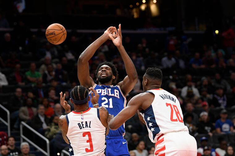 Sixers center Joel Embiid (21) loses the ball after he was fouled by Washington Wizards guard Bradley Beal (3) during the first half.