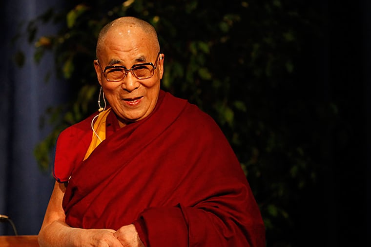 The Dalai Lama greets the crowd upon his arrival for "Develop The Heart: A talk with his Holiness the 14th Dalai Lama" held in Jadwin Gymnasium on the Princeton campus Tuesday, Oct. 28, 2014. (MICHAEL S. WIRTZ / Staff Photographer)