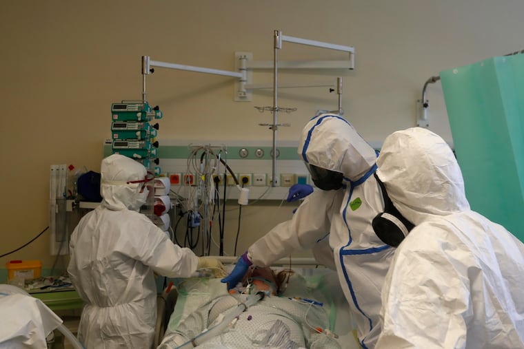 Health care workers prepare to transport a COVID-19 patient from an intensive care unit (ICU) at hospital in Kyjov to hospital in Brno, Czech Republic, Thursday, Oct. 22, 2020. In El Paso, Texas, residents have been urged to stay home for amid a spike in coronavirus cases.