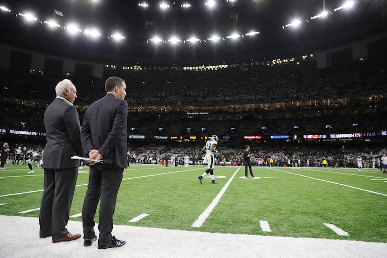 Eagles owner Jeffrey Lurie, left, and executive vice president of football operations Howie Roseman watching from the sideline before the Eagles played the Saints in the playoffs in January.