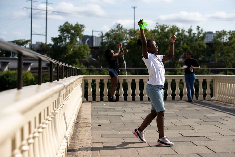 Mercedes Holloway (left)and her niece Lia (right) fly kites at Water Works in Fairmount Park during a heat wave last summer. Here comes another one.