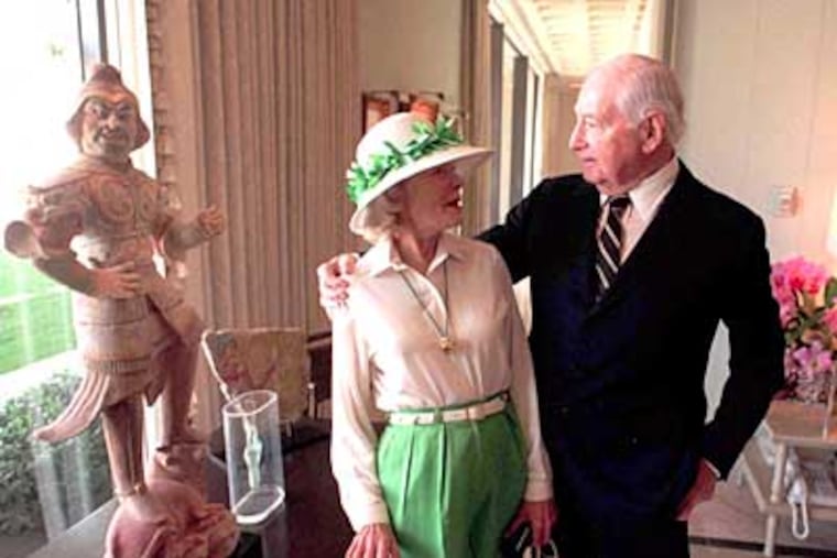 Leonore and Walter Annenberg chat at Sunnylands Estate in 1995 with a Tang Dynasty statue to the left. (Charles Fox / Staff Photographer)