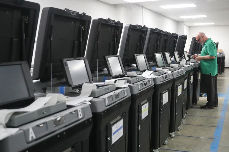 John Ross, voting machine technician, works to make sure machines are functioning properly ahead of Election Day at the Chester County Government Services Building in West Chester.