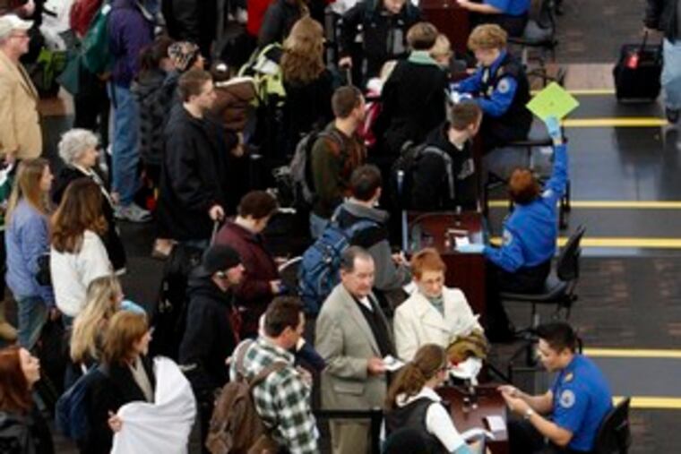 Passengers line up to pass through security as flights were delayed at Denver International Airport after the crash.