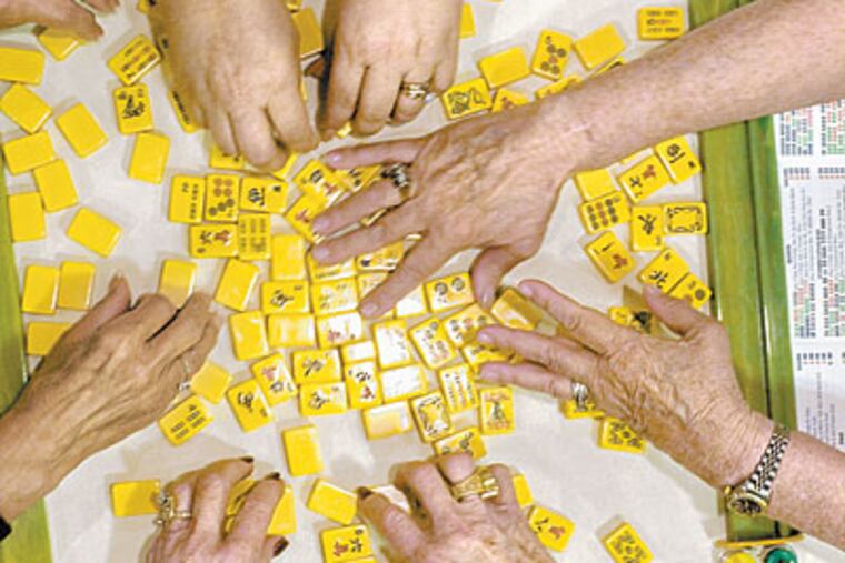 With 34 tables of players, the Four Seasons Mah-Jongg Tournament last month in Lancaster was evidence of the game's popularity. (CLEM MURRAY / Inquirer)