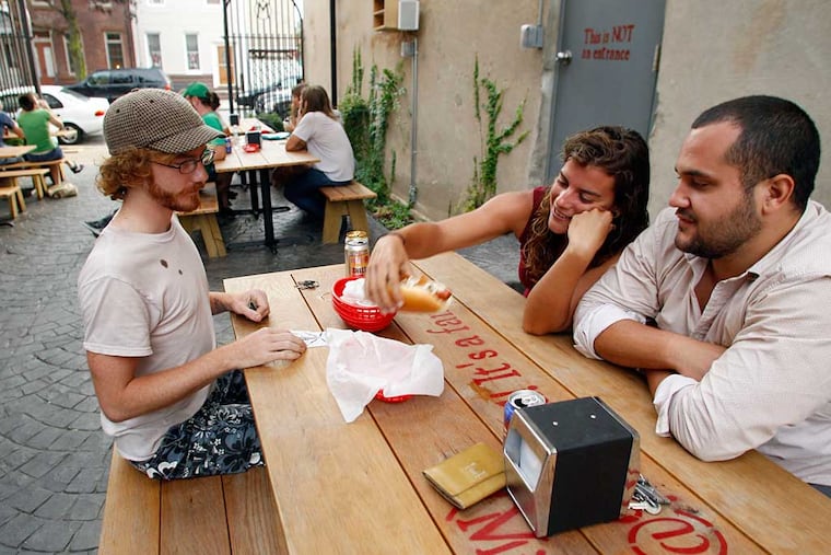 Diners eat at the Memphis Taproom beer garden in previous years. The owners plan to reopen the beer garden as soon as possible.
