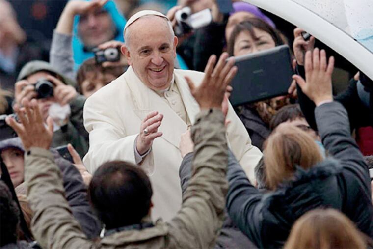 The Vatican's World Meeting of Families is expected to draw hundreds of thousands to Philly in Sept. 2015 - even more if the Pope attends. Philly Archbishop Chaput, Gov. Tom Corbett and Mayor Nutter are expected to meet March 26 with the Pope to discuss the event. (ALESSANDRA TARANTINO / AP /File)