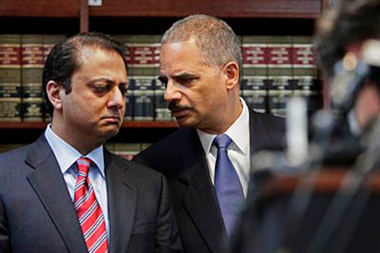 U.S. Attorney General Eric Holder, right, and U.S. Attorney for New York's Southern District Preet Bharara confer at a news conference on Thursday, Jan. 20, 2011, in New York. Law enforcement officials said more than 120 organized crime associates face charges including murder, extortion and narcotics trafficking in one of the largest Mafia crackdowns in FBI history. (AP Photo/Bebeto Matthews)