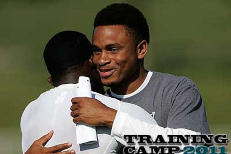 Nnamdi Asomugha (right) is greeted by Michael Vick, who recruited him to join the Eagles. (Rich Schultz/AP)