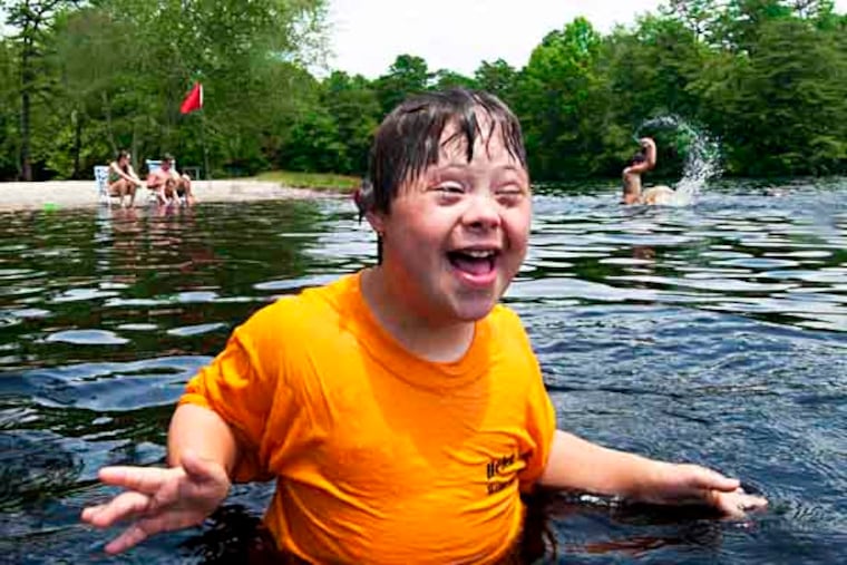 Camper Reece Witmer, 9, of Millersburg, enjoys a dip in Lake Nummy at Belleplain State Forest. For many visiting the Helen L. Diller Vacation Home for the Blind, it's their first exposure to the Shore and to an amusement park. ( APRIL SAUL / Staff )