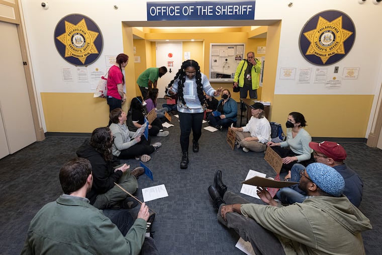Activists protest inside the office of Sheriff Bilal in Philadelphia on Thursday.