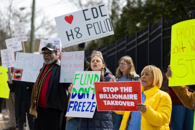 Demonstrators protest Centers for Disease Control and Prevention (CDC) layoffs in front of the CDC headquarters in Atlanta on Tuesday, Feb. 18, 2025. (Arvin Temkar/Atlanta Journal-Constitution via AP)