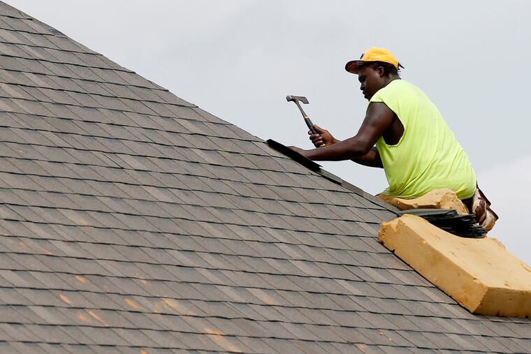 A roofer balances on a steep slope as he lays down shingles. All roofs are designed to shed water, but they are categorized as either low-slope or steep-slope. Most residences are steep-slope.
