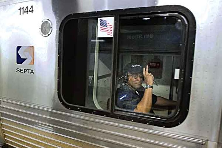 A SEPTA engineer signals with two fingers as builds speed to leave the 8th St. station on the Market-Frankford line, May 22, 2013. ( DAVID M WARREN / Staff Photographer )