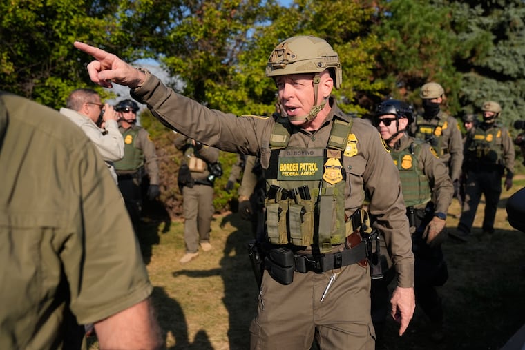 Greg Bovino, the chief patrol agent for the U.S. Border Patrol El Centro sector, center, walks with federal immigration agents near an Immigration and Customs Enforcement facility in Broadview, Ill., in October.