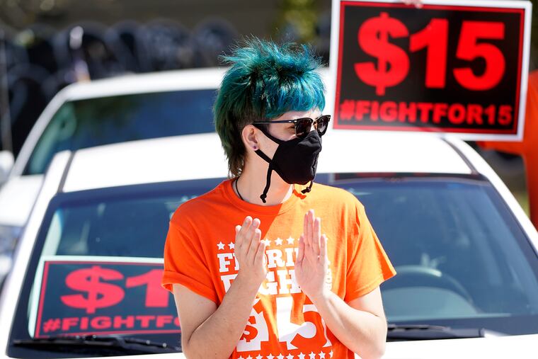 Cristian Cardona, an employee at a McDonald's, attends a rally for a $15 an hour minimum wage Tuesday, Feb. 16, 2021, in Orlando, Fla.