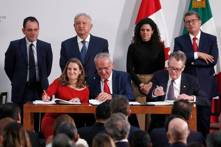 Deputy Prime Minister of Canada Chrystia Freeland, left, Mexico's top trade negotiator Jesus Seade, center, and U.S. Trade Representative Robert Lighthizer, sign an update to the North American Free Trade Agreement, at the national palace in Mexico City, Tuesday, Dec. 10. 2019.