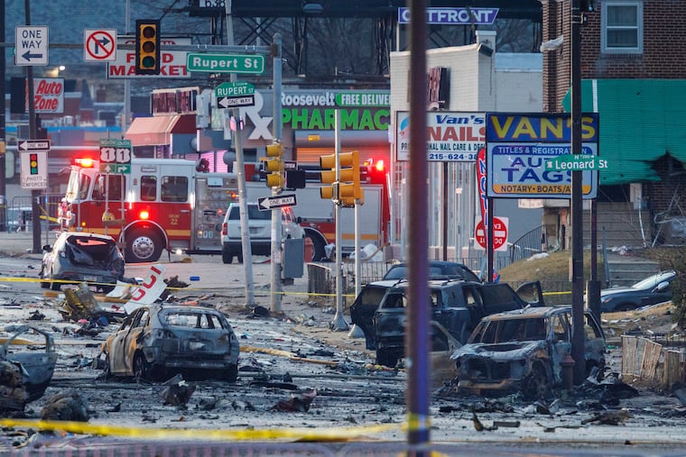 Burned cars and debris from a medical jet crash along Cottman Avenue near Rupert Street as seen early Saturday morning on Feb. 1, 2025. The National Transportation Safety Board released evidence in its investigation into the crash on Tuesday, Aug. 18, 2026.