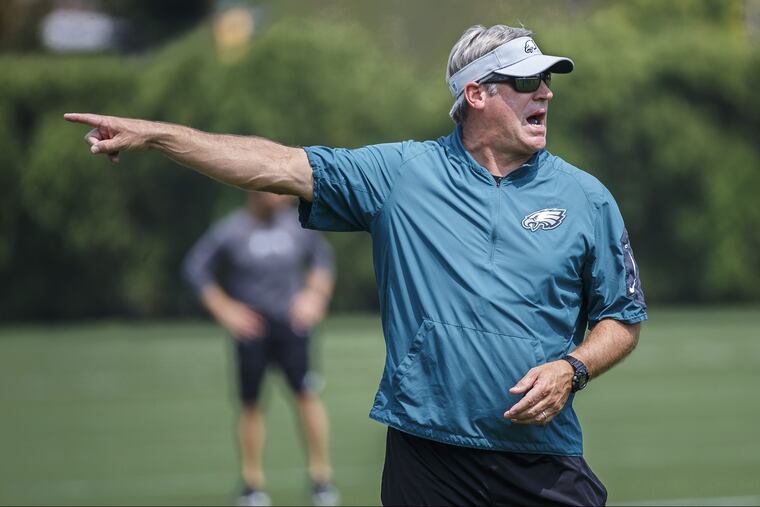 Eagles head coach Doug Pederson directs a passing drill during Monday's practice at the NovaCare Center on August 27, 2018. MICHAEL BRYANT / Staff Photographer