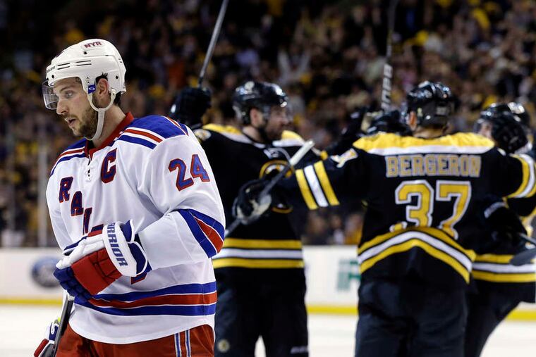 The Rangers' Ryan Callahan skates away as the Bruins celebrate a second-period goal. (ELISE AMENDOLA / Associated Press)