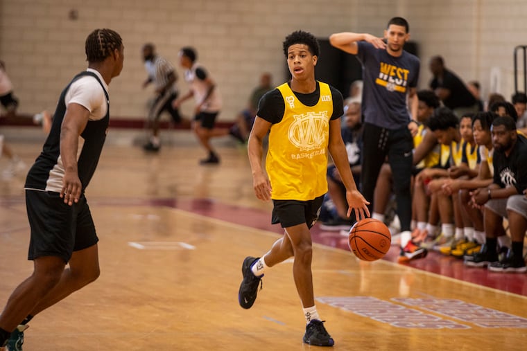 West Catholic's Adam "Budd" Clark looking for an open teammate during a game against Hayfield Secondary School during the Philly Live Basketball Tournament in June.
