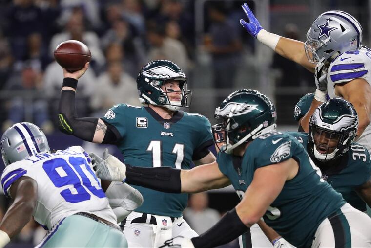 Eagles’ Carson Wentz, left, throws during the 2nd quarter as the Philadelphia Eagles play the Dallas Cowboys in Arlington, Texas on November 19, 2017.