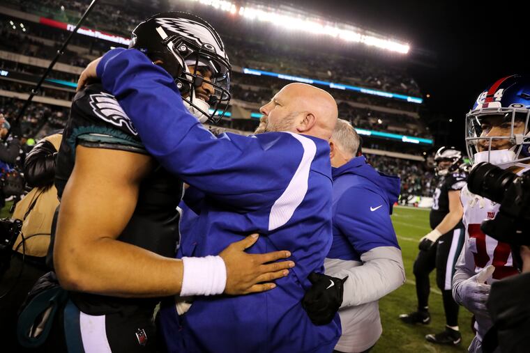 Eagles quarterback Jalen Hurts talks with Giants coach Brian Daboll after the regular-season finale at Lincoln Financial Field.