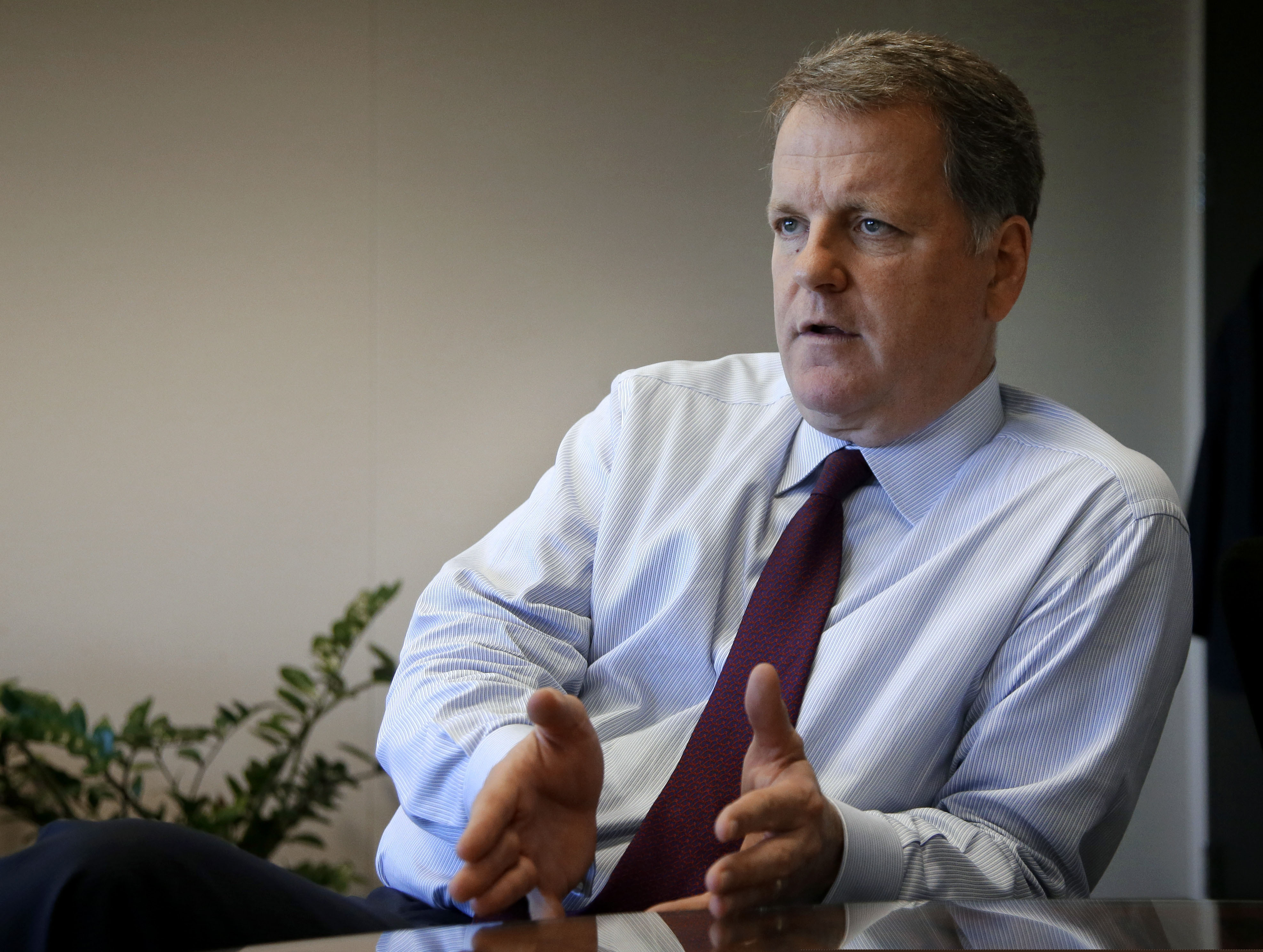 In a file photo, U.S. Airways CEO Doug Parker responds to a reporters question during an interview at AMR headquarters in Fort Worth, Texas. Parker, American Airlines CEO, said checking passengers for proof of vaccination “wouldn’t be physically possible” on domestic flights without causing enormous delays. (AP Photo/Tony Gutierrez, File)