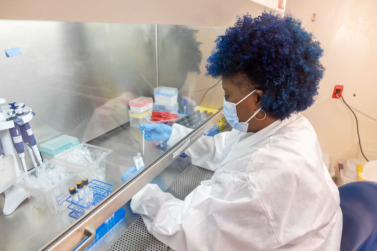 Vanessa Dicks, 46, prepares patients' nasal swabs to undergo a diagnostic test for the identification of SARS-CoV-2. Dicks is one of 50 new full-time lab assistants hired by Penn Medicine through a partnership with the West Philadelphia Skills Initiative.
