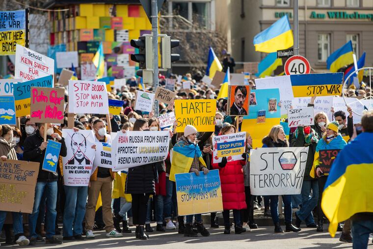 Numerous people demonstrate with signs and flags on Wilhelmsplatz in Stuttgart, Germany, against Russia's war against Ukraine on Saturday.