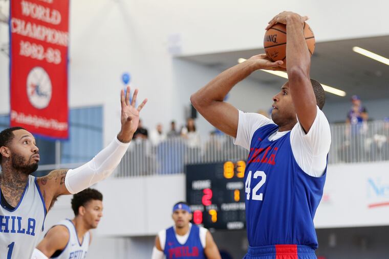 Sixers center/forward Al Horford shoots past forward Mike Scott (1) during the team's Blue and White scrimmage in Wilmington.