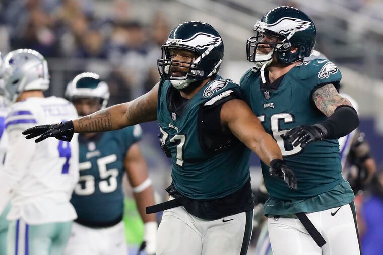 Eagles defensive end Michael Bennett and defensive end Chris Long celebrate a stop against the Dallas Cowboys on Sunday, December 9, 2018 in Arlington, TX. Bennett stripped the football from Dallas Cowboys quarterback Dak Prescott on the play. YONG KIM / Staff Photographer