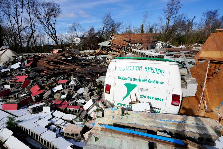 Damage from a tornado is seen in Mayfield, Ky., on Saturday. As many as 100 people might have been killed in the state, the governor said.