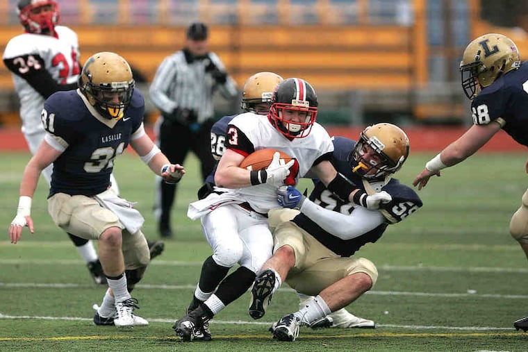 La Salle's Joe Naji brings down Easton's Zack Bambry as Connor Daly trails the play. Daly registered a team-high 12 tackles, including eight solo stops, in the Explorers' win. "It's a pretty incredible feeling to be part of this," the senior said.