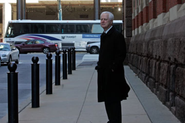 Ted Lewis, president of the Pennsylvania Academy of Fine Arts, stands next to the Academy museum. Behind him is the construction of the Pa. Convention Center. ( Bonnie Weller / Staff Photographer )