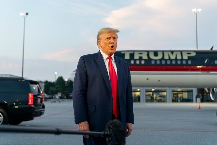 Former President Donald Trump speaks with reporters before departure from Hartsfield-Jackson Atlanta International Airport last week.