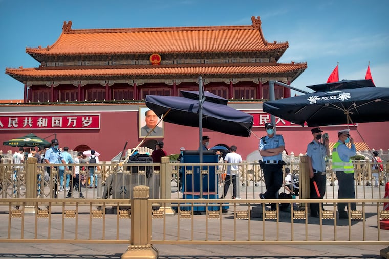 Chinese police stand guard in front of Tiananmen Gate in Beijing.