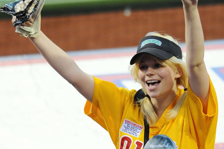 Emily Youcis, shown selling pistachios at a Phillies game in 2011, says she is a staunch supporter of Donald Trump and the white-supremacy movement. Friends claim her so-called political beliefs are just a scam to drum up publicity for her animation career.
