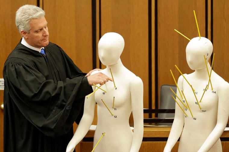 Judge John P. O'Donnell uses mannequins with gunshot wounds indicated to show that Officer Michael Brelo's shots alone didn't necessarily cause the deaths.