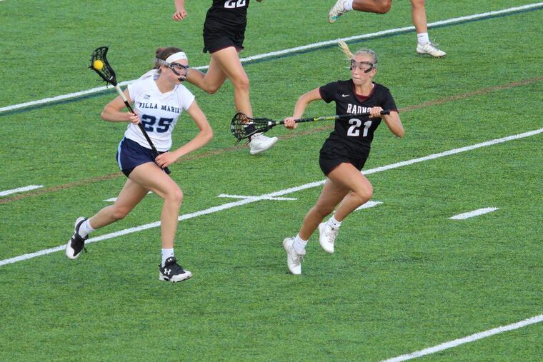 Villa Maria's Abby Walheim (left) runs against Radnor in the semifinals.