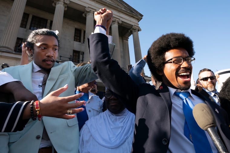 State Rep. Justin Jones (left) and expelled State Rep. Justin Pearson raise their hands just before Jones takes the oath of office outside the state Capitol on Monday, April 10, 2023, in Nashville, Tenn. Jones, who along with Pearson was expelled last week over their role in a gun-control protest on the House floor in the aftermath of a deadly school shooting, was reinstated Monday after Nashville’s governing council voted to send him straight back to the legislature.