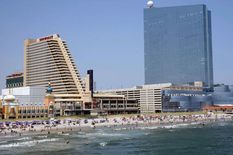 The Showboat (left) and the Revel. New Revel owner Glenn Straub would buy the Showboat from the college. (AP File)