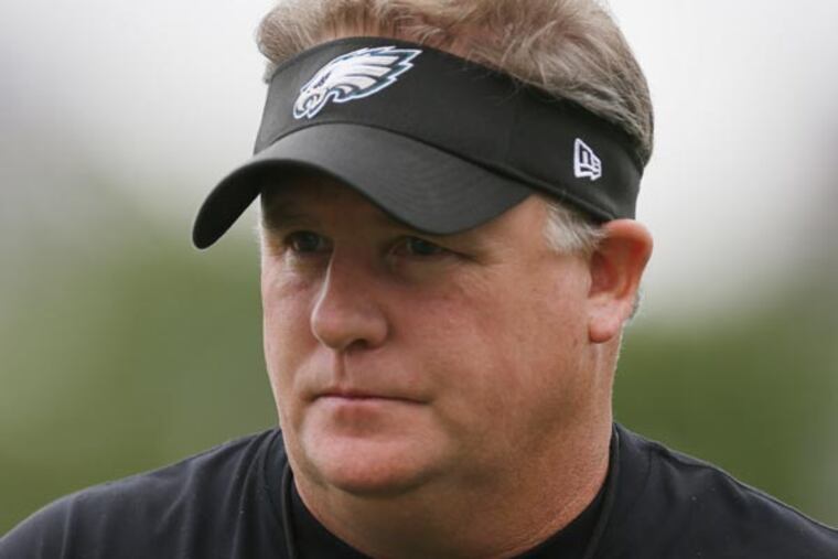 Chip Kelly walks on the field during a joint workout with the New England Patriots at NFL football training camp in Philadelphia, Wednesday, Aug. 7, 2013. (Matt Rourke/AP)