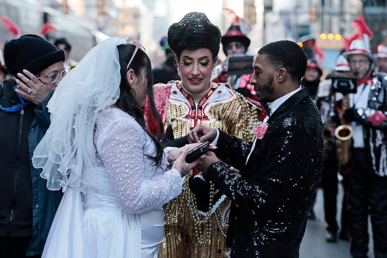 Hegeman String Band captain Kelliann Gallagher officiates the wedding of Julianna Bonilla (left) and Stanley Wells (right) during the 2026 Mummers Parade in Philadelphia on Thursday, Jan. 1, 2026.