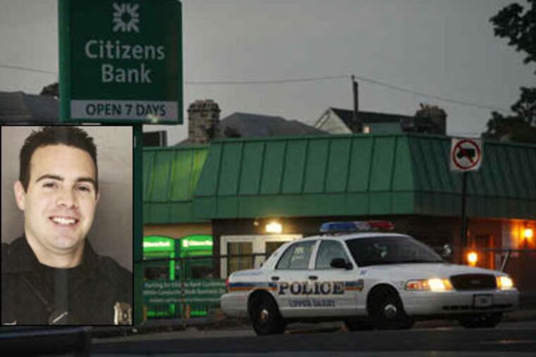 Upper Darby police at the scene of the shootout involving Officer Ray Blohm (inset) early yesterday at Copley Road and Ludlow Street.