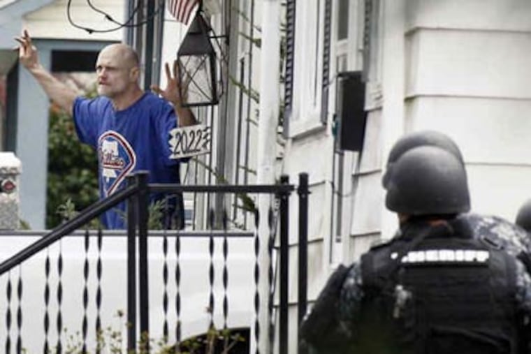 Kevin Anthony, 42, of Wayne Avenue in Haddon Heights, surrenders to police. Police said he severely beat a man Thursday night and then barricaded himself in his home for hours yesterday morning.