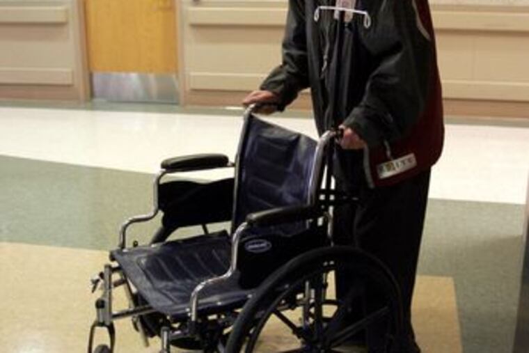 Jim Sullivan takes a wheelchair to a patient at the Tucson, Ariz., Veterans Affairs Medical Center. Despite battling cancer, Sullivan still volunteers six days a week at the Medical Center.