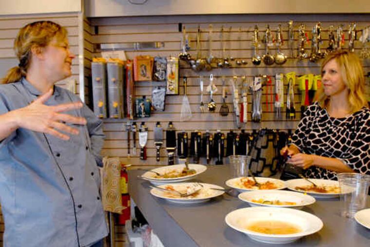 Chef Elise Fellinger Henry talks with a student, Kristy Kreizinger, a flight attendant who is taking the class "to have real meals ready for my fiance when I'm gone." Interest in the region's cooking classes burgeons, partly because of the economy.