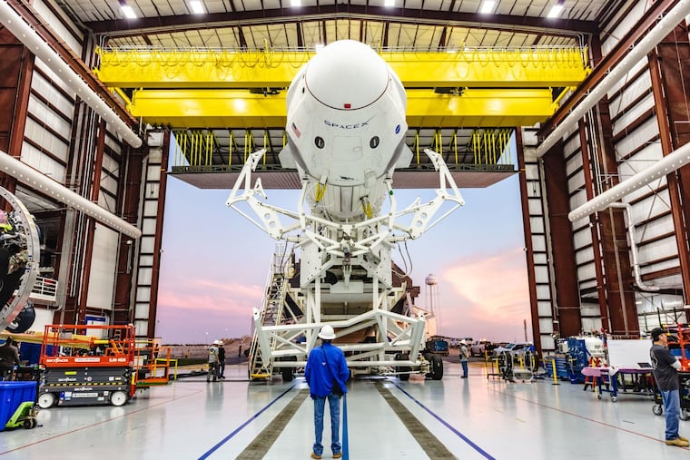 SpaceX's Falcon 9 rocket, with its Crew Dragon capsule attached, rolls out of the company's hangar at NASA's Kennedy Space Center in Florida in January 2019.
