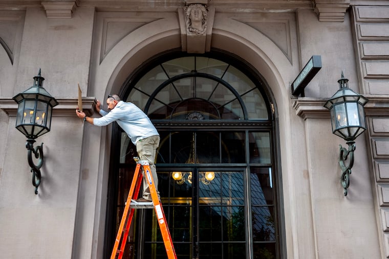 October 7, 2024: Masonry contractor Jon Goodroad works on the facade of the Academy of Music.